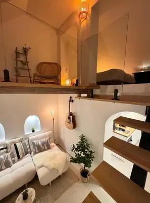 a living room with a white couch and a guitar at tiny BEACH HOUSES - 2 min to Beach in Salema