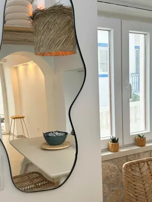 a mirror in a room with a table and a bowl at tiny BEACH HOUSES - 2 min to Beach in Salema