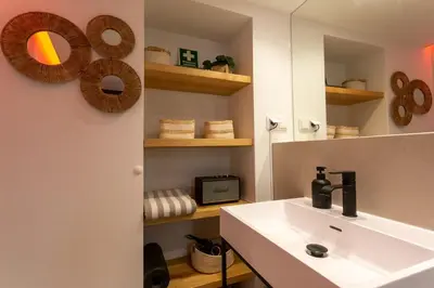 a bathroom with a sink and a mirror at tiny BEACH HOUSES - 2 min to Beach in Salema