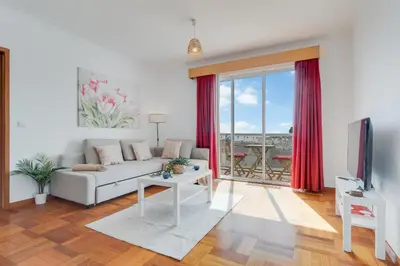 a living room with a couch and a tv at Camara de Lobos Apt by Holiday Rental Madeira in Câmara de Lobos