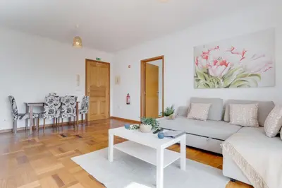 a living room with a white couch and a table at Camara de Lobos Apt by Holiday Rental Madeira in Câmara de Lobos