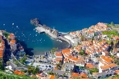 an aerial view of a town next to the ocean at Camara de Lobos Apt by Holiday Rental Madeira in Câmara de Lobos