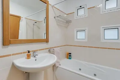 a bathroom with a sink and a bath tub at Camara de Lobos Apt by Holiday Rental Madeira in Câmara de Lobos