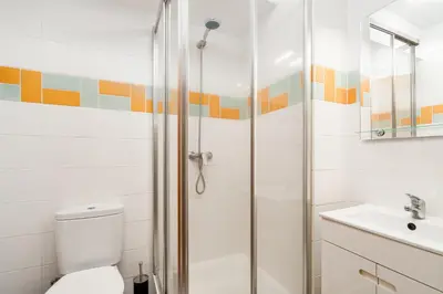 a bathroom with a shower and a toilet and a sink at New Santa Cruz Airport & Downtown Apartment in Santa Cruz