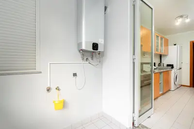 a white kitchen with a shower and a sink at New Santa Cruz Airport & Downtown Apartment in Santa Cruz