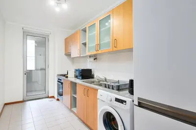 a kitchen with a washer and dryer in it at New Santa Cruz Airport & Downtown Apartment in Santa Cruz