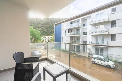 an apartment balcony with a view of a parking lot at New Santa Cruz Airport & Downtown Apartment in Santa Cruz