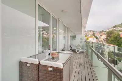 a bathroom with two sinks on a balcony at Plaza city center- Balcony amazing views in Funchal