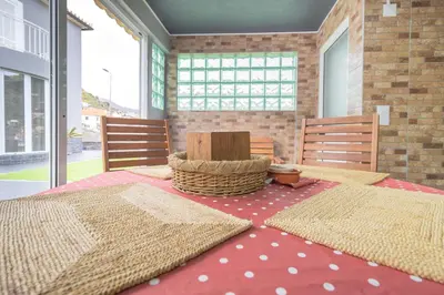 a room with two tables and two chairs and a room with windows at Villa Machico Valley Flat 2 in Machico