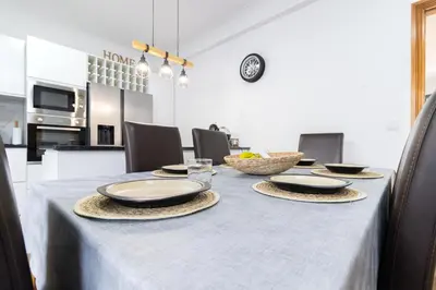 a table with plates and bowls on top of it at Villa Machico Valley Flat 2 in Machico