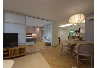 a living room with a dining table and a bedroom at Shell Living - Marina in Funchal