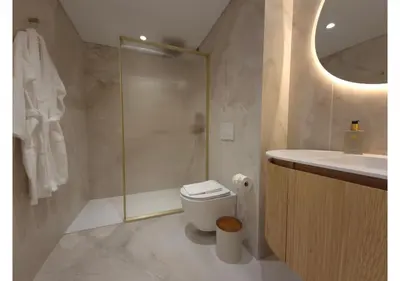 a bathroom with a shower and a toilet and a sink at Shell Living - Marina in Funchal