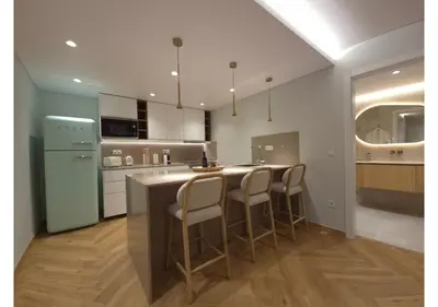 a kitchen with a island with bar stools at Shell Living - Marina in Funchal