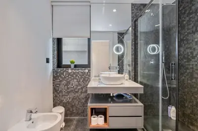 a bathroom with a sink and a shower at Apartamento Moderno T2 com Pátios e Acesso a Piscina in Funchal