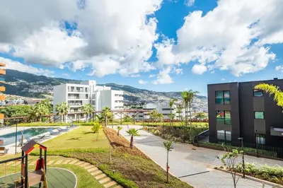 a view of a city with buildings and a park at Apartamento Moderno T2 com Pátios e Acesso a Piscina in Funchal