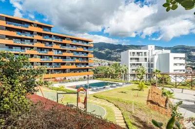 a resort with a swimming pool and buildings at Apartamento Moderno T2 com Pátios e Acesso a Piscina in Funchal