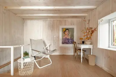a living room with a chair and a desk at Apple Tree House in Santa Cruz
