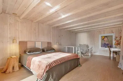 a bedroom with a bed in a room with wooden ceilings at Apple Tree House in Santa Cruz