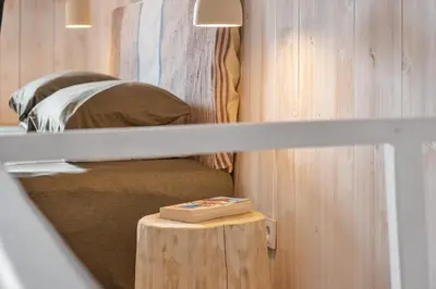 a room with a bed and a table with a mirror at Apple Tree House in Santa Cruz
