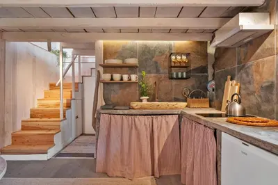 a kitchen with a counter top and a staircase at Apple Tree House in Santa Cruz