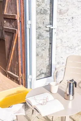 a table with glasses on it next to a door at Apple Tree House in Santa Cruz