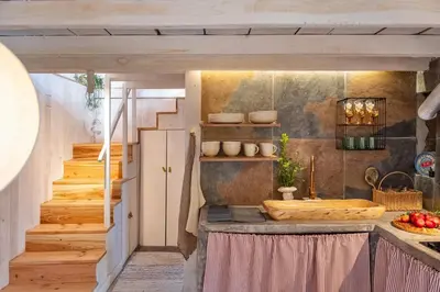 a kitchen with a counter and a staircase at Apple Tree House in Santa Cruz