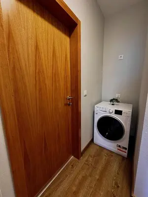 a small room with a microwave and a door at Adega Do Avô, Madeira Island in Ponta Delgada