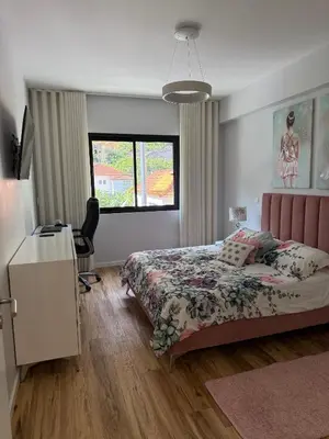 a bedroom with a bed and a desk and a window at Visconde II F in Ribeira Brava