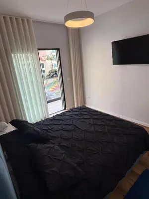 a bedroom with a large black bed with a window at Visconde II F in Ribeira Brava