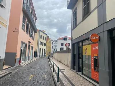 an empty street in a city with buildings at Old Town Charm Apartment Funchal in Funchal