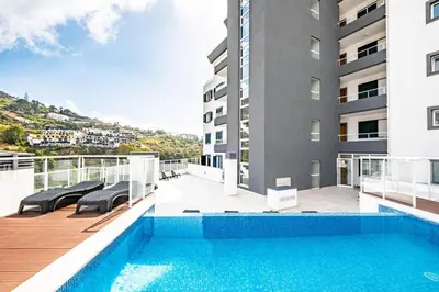 a swimming pool on the balcony of a building at Sunflower Gem by Homie in Caniço