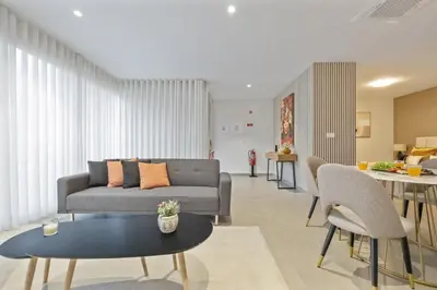 a living room with a couch and a table at Sunflower Gem by Homie in Caniço