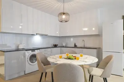 a kitchen with a table with a plate of food on it at Sunflower Gem by Homie in Caniço