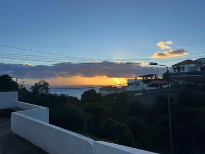 a view of the sunset from a house at Latin House in Funchal