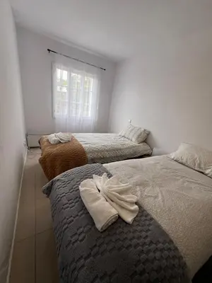 a bedroom with two beds with towels on them at Latin House in Funchal