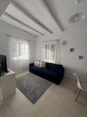 a living room with a blue couch and a tv at Latin House in Funchal