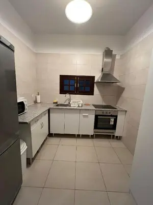 a kitchen with a sink and a stove top oven at Latin House in Funchal