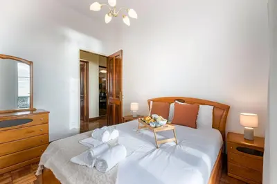 a bedroom with a white bed with towels on it at Casa da Georgina by GALMI in Arco da Calheta