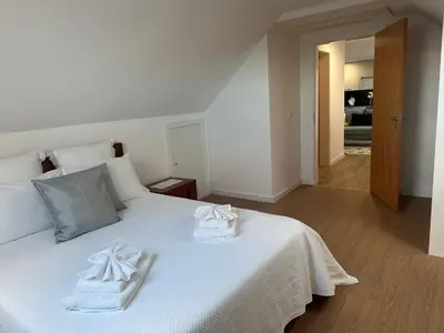 a bedroom with a white bed with towels on it at Refugio da Ponta do Sol 2 - Madeira Inn Group in Ponta do Sol