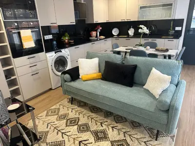 a living room with a couch and a kitchen at Refugio da Ponta do Sol 2 - Madeira Inn Group in Ponta do Sol