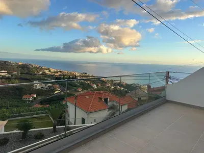 a view of the ocean from the balcony of a house at Refugio da Ponta do Sol 2 - Madeira Inn Group in Ponta do Sol