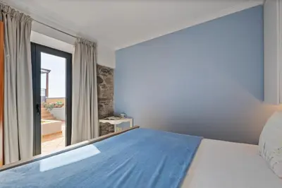 a bedroom with a bed and a large window at Quinta do Checa by Homie in Quinta Grande