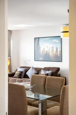 a living room with a couch and a glass table at Ocean Vista- T2 Funchal in Bicas