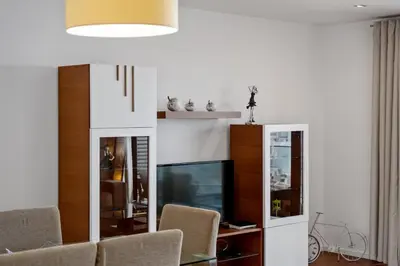 a living room with a tv and a table and chairs at Ocean Vista- T2 Funchal in Bicas
