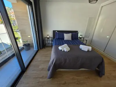 a bedroom with a bed with two pillows on it at Glendeira Lux Apartment in Caniço