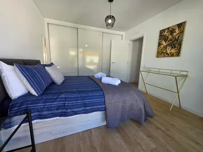 a bedroom with a bed with two towels on it at Glendeira Lux Apartment in Caniço