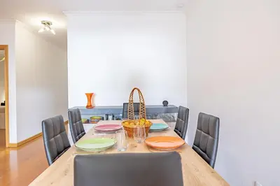 a dining room with a table and chairs at Ocean Life by YOUR KEY MADEIRA in Caniço
