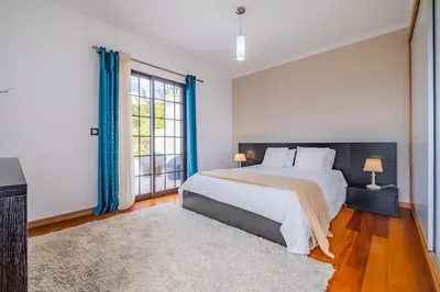 a bedroom with a large bed and a large window at Country Escape in Ribeira Brava