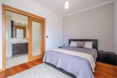 a bedroom with a large bed and a bathroom at Country Escape in Ribeira Brava