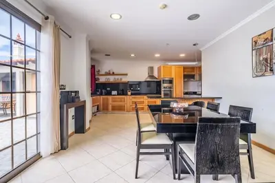 a kitchen with a dining table and chairs in a room at Country Escape in Ribeira Brava